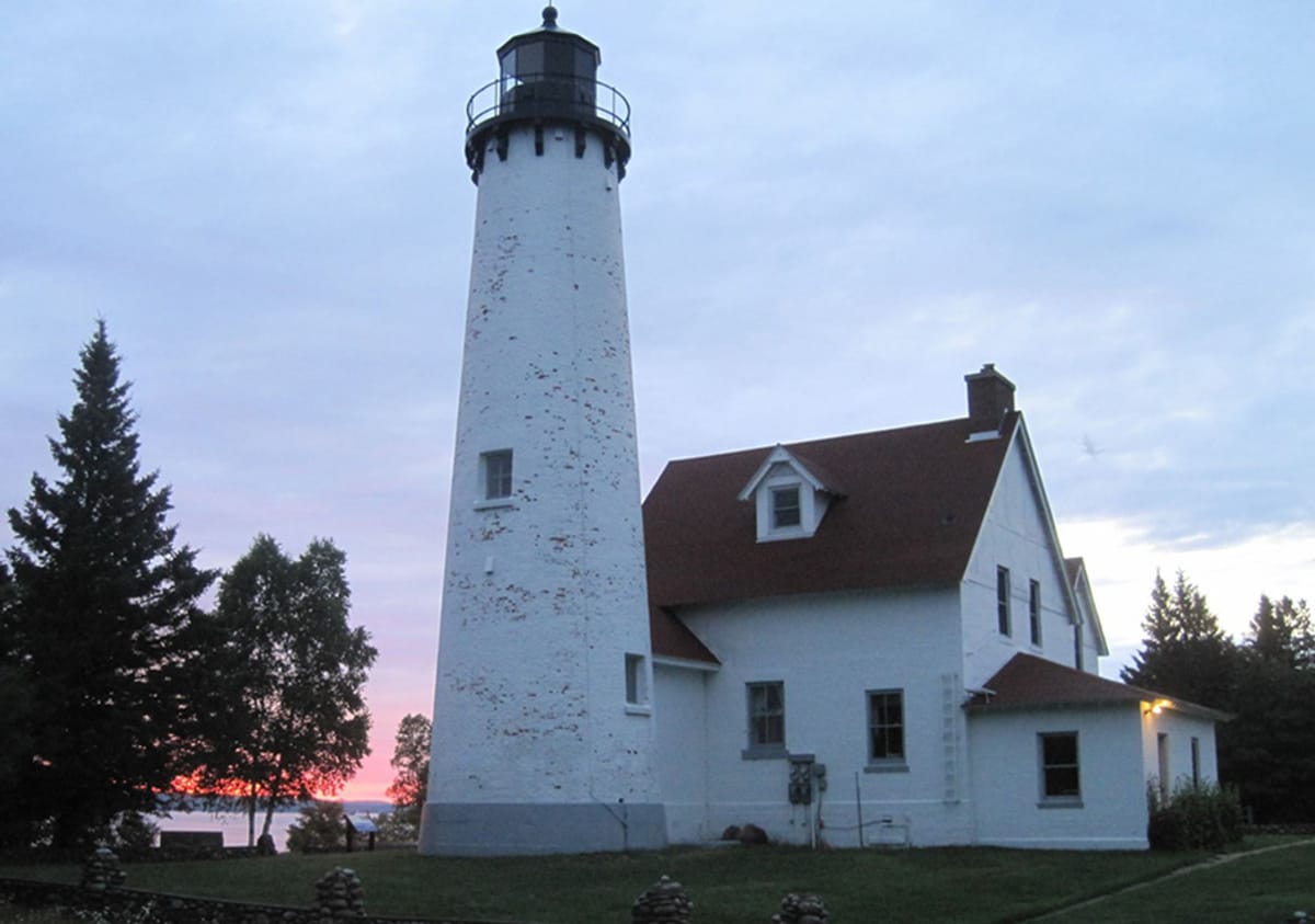 Point Iroquois Lighthouse looms above the trees, still guiding ships in the night