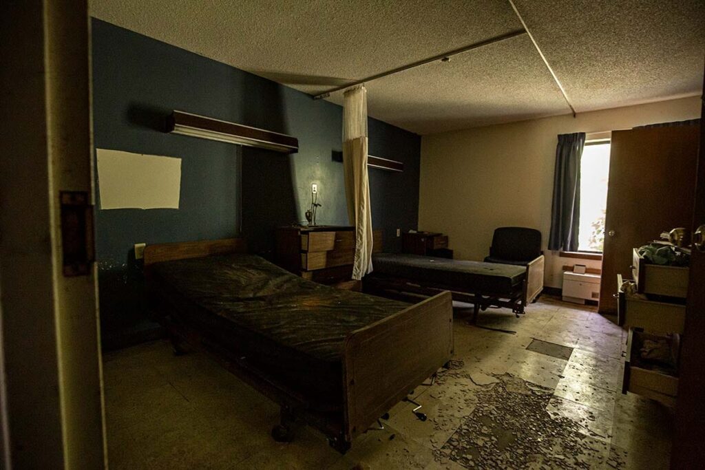 Patient rooms with personal items still inside litter the building